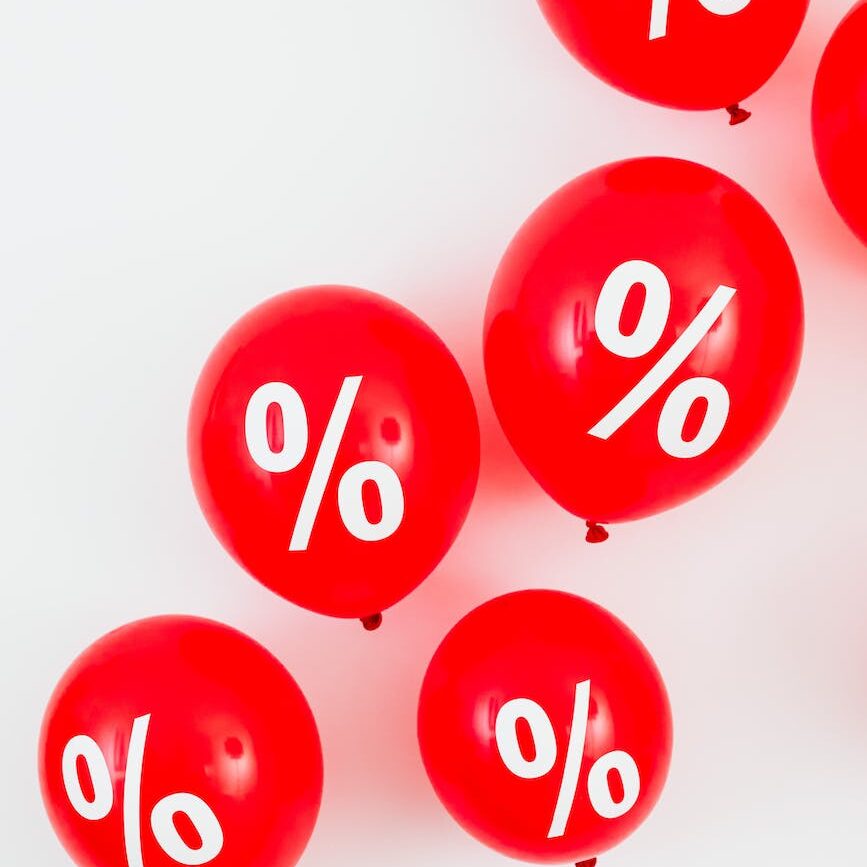 red balloons with percentage symbols on white background